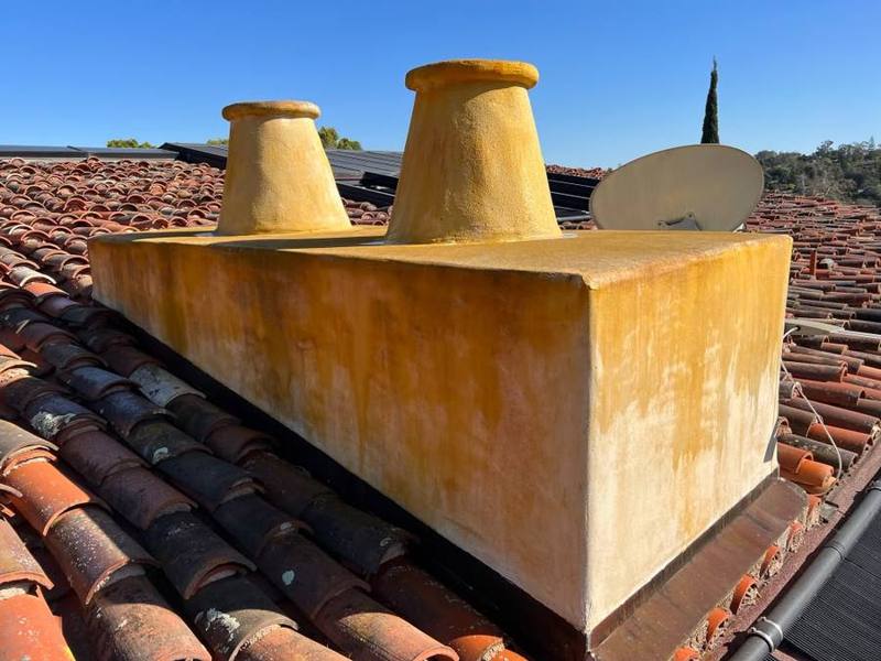 Stucco chimney with orange staining