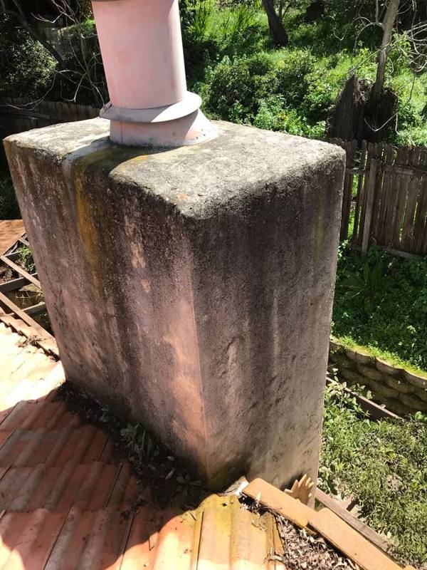 Stucco chimney with dark staining