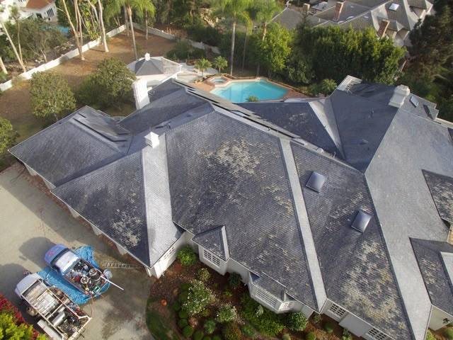 Aerial view of a slate roof covered in lichen