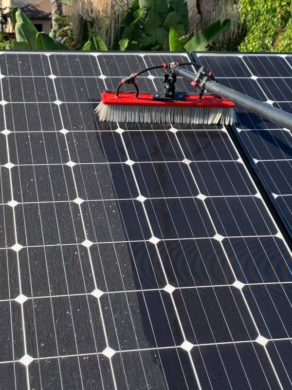 Brushing dust off solar panels
